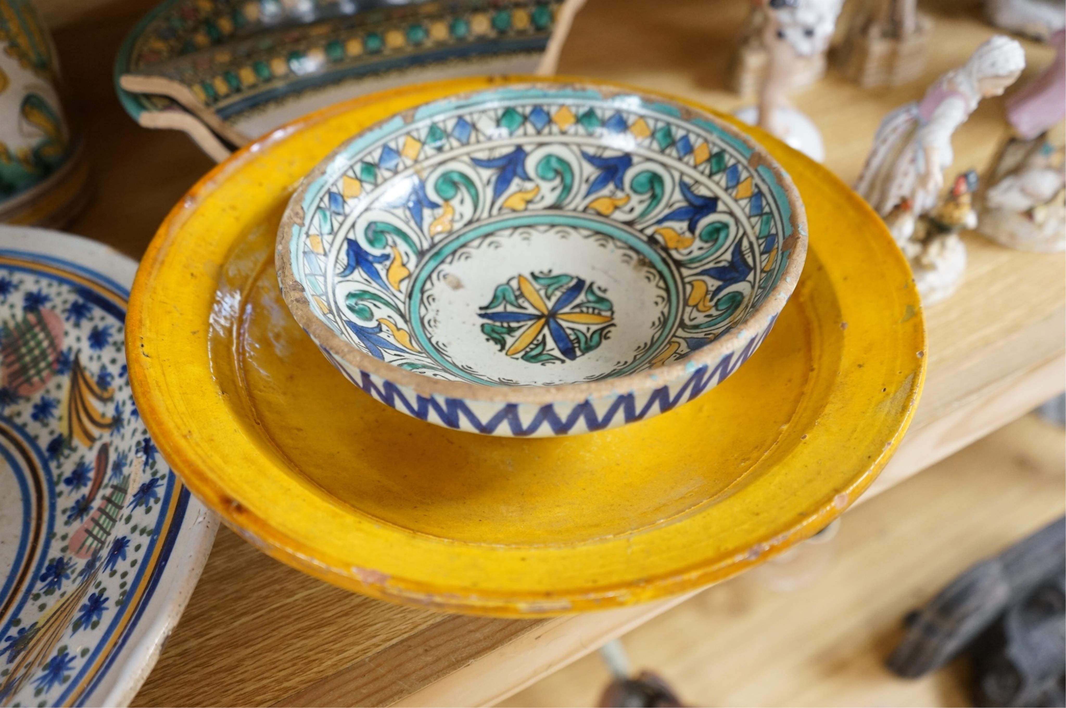 A late 17th century Spanish tin glazed jug together with Moroccan and pottery bowls and dishes (5). Jug 26cm high.